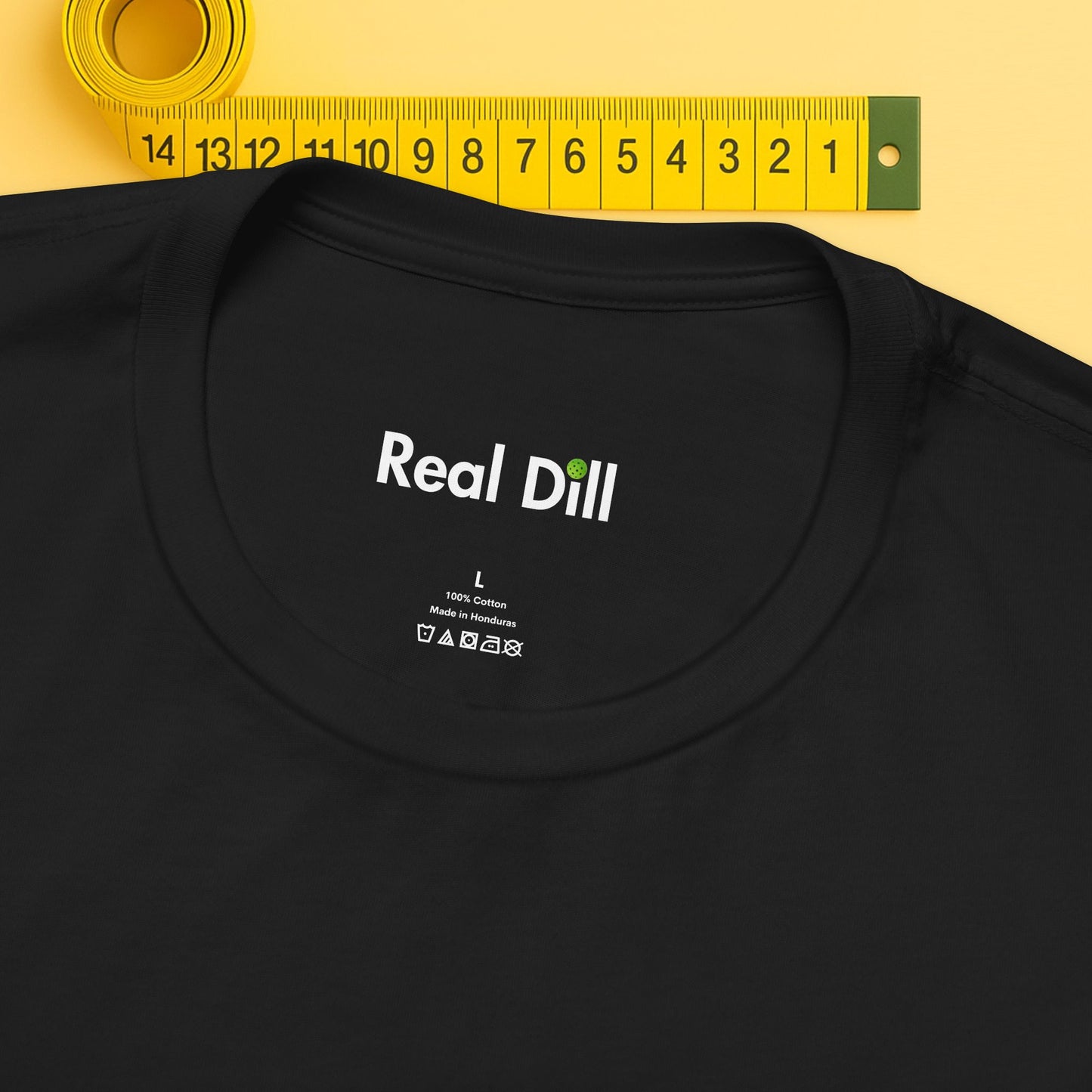 black close-up of neck label – real dill pickleball shirt branding