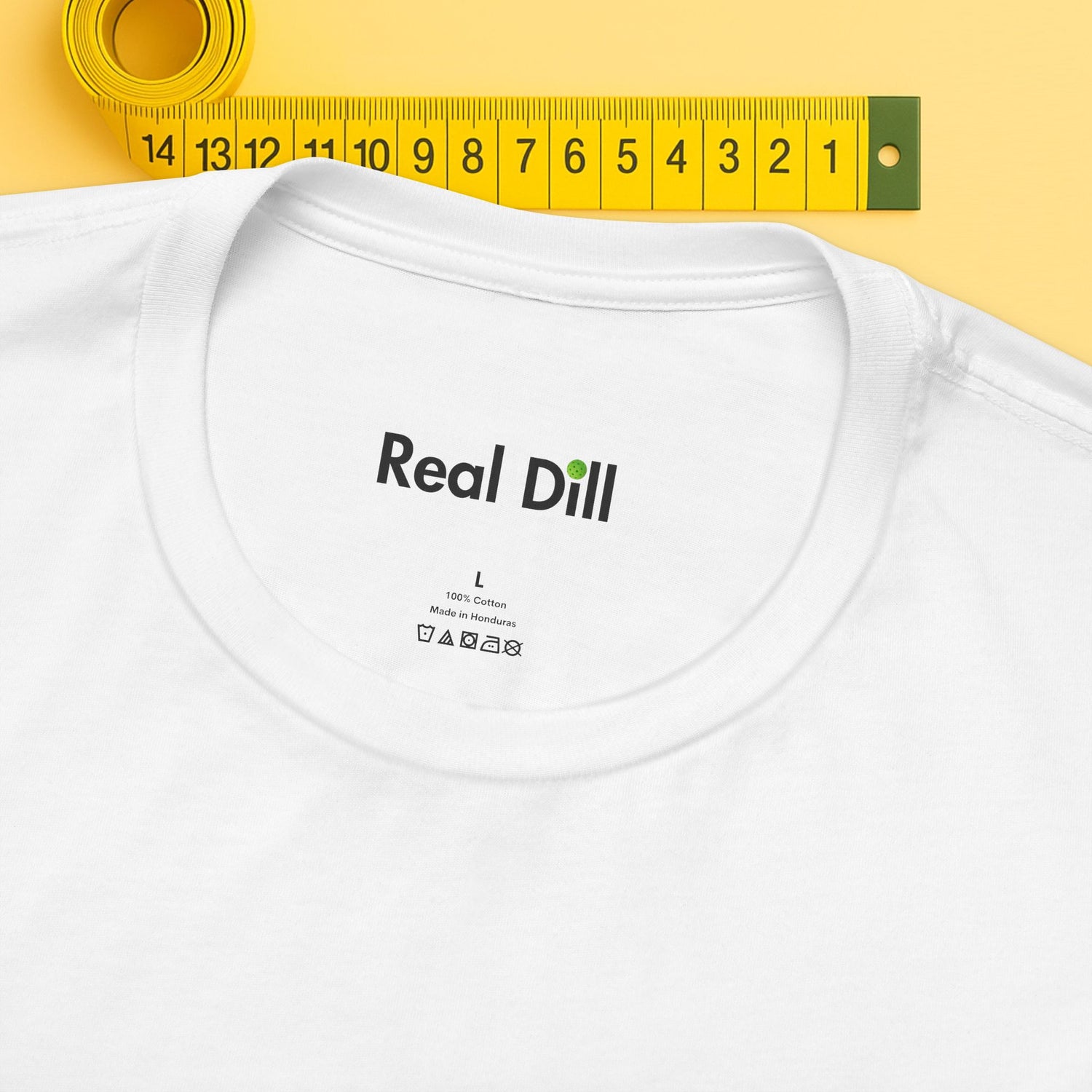 white close-up of neck label – real dill pickleball shirt branding